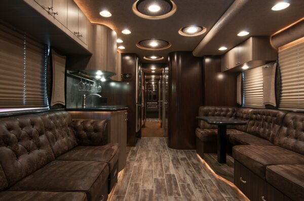 Luxury interior of a vehicle with brown leather seating and modern design elements.