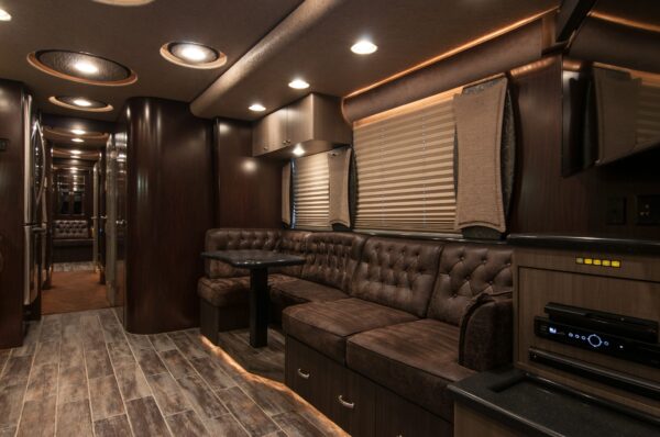 Luxury interior of a vehicle with brown leather seating and modern design elements.