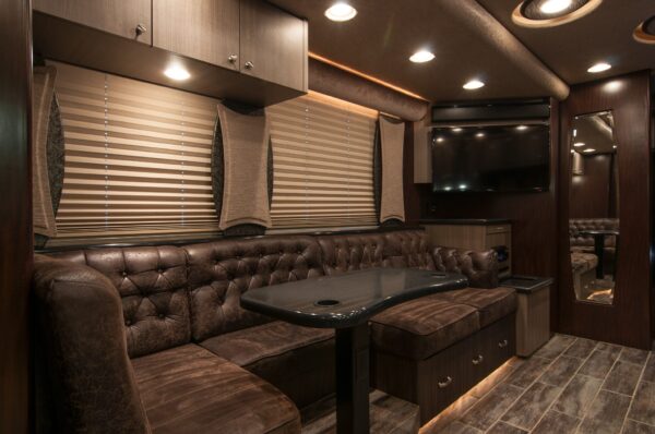 Luxury interior of a recreational vehicle with leather seating and modern decor.