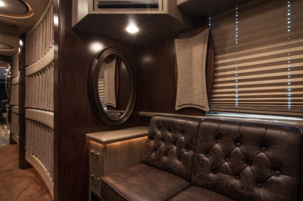 Luxury interior of a vehicle with brown leather seats and a mirror.