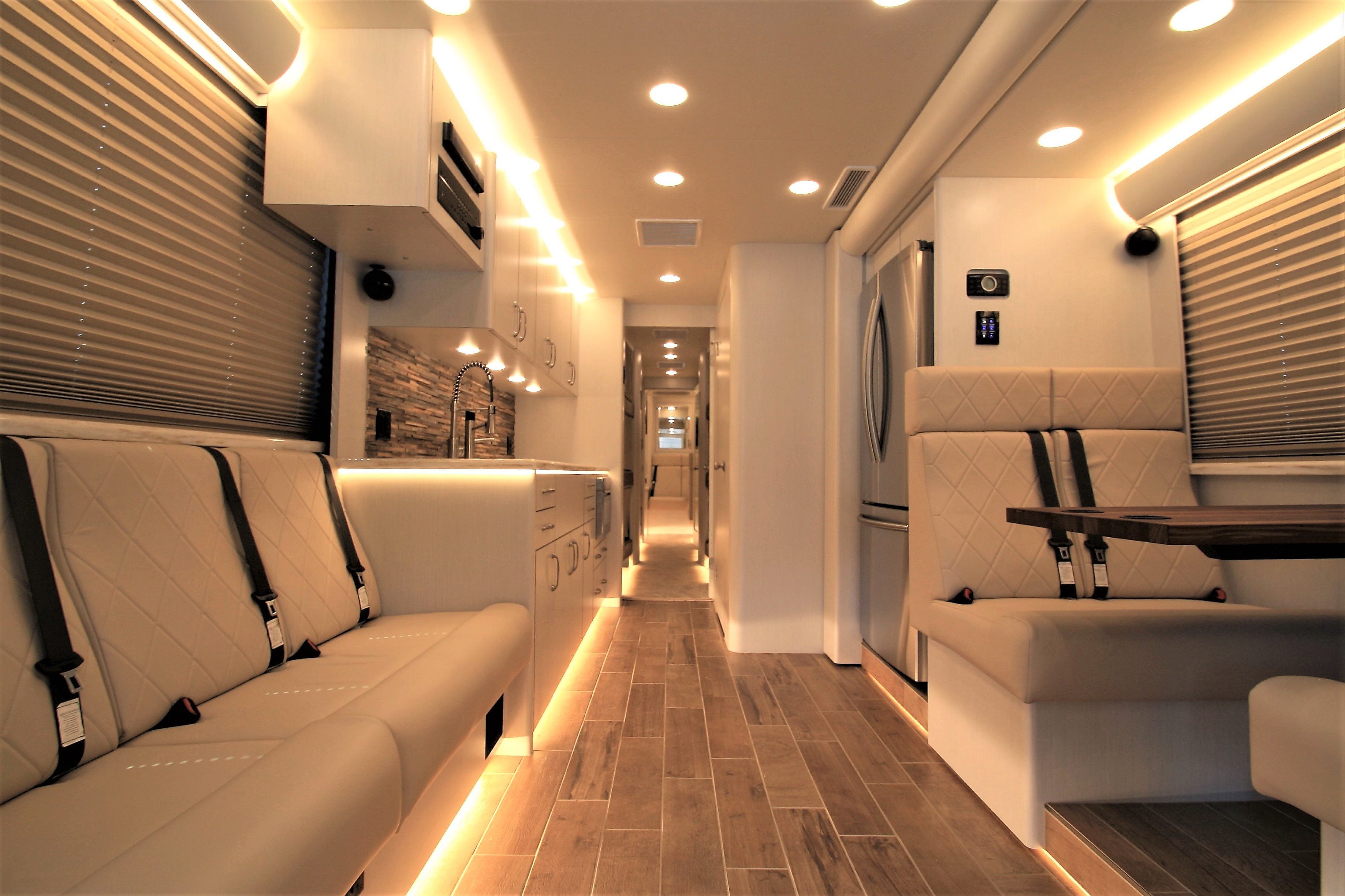 Interior of a modern vehicle with seating and lighting