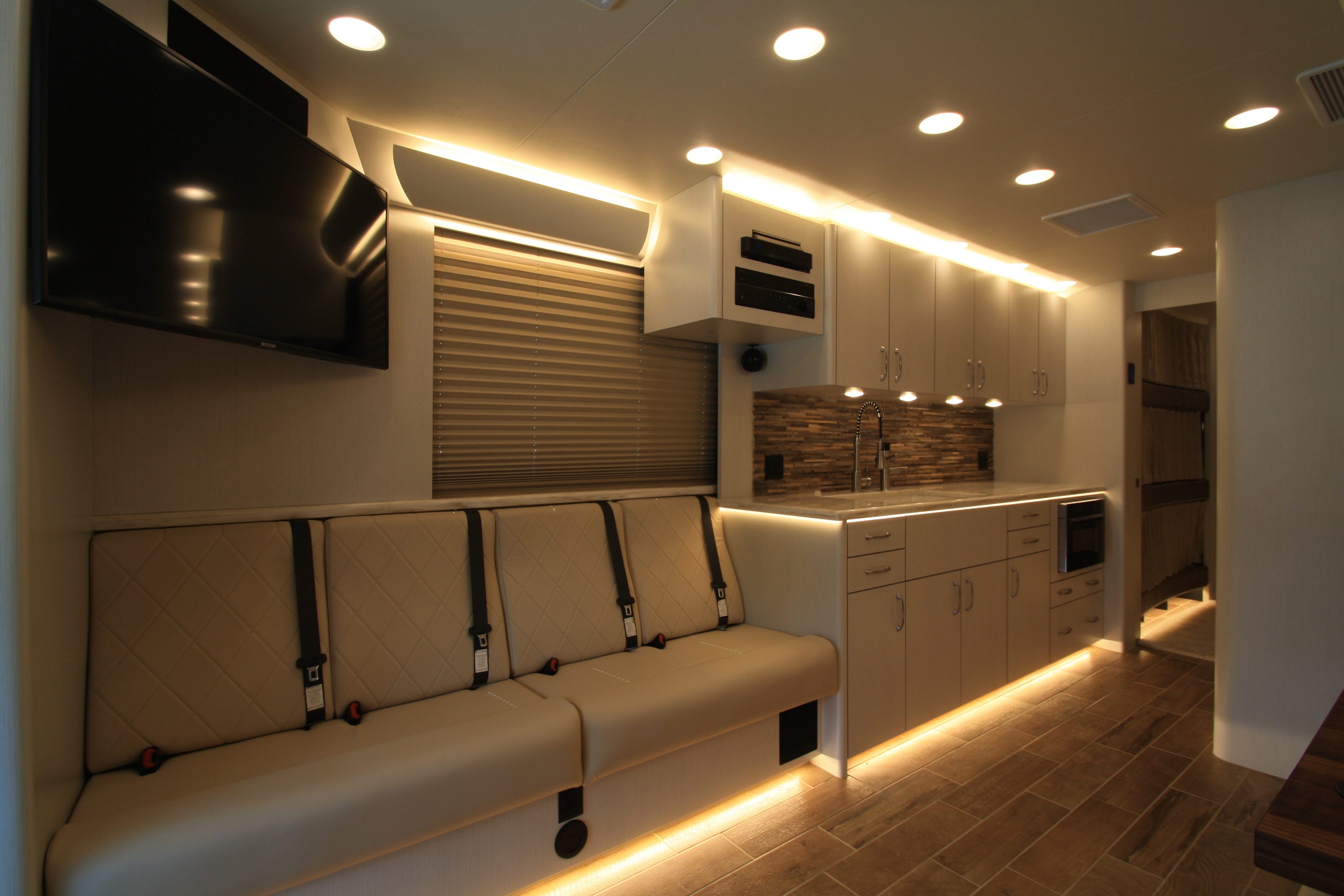 Modern kitchen interior with built-in seating and ambient lighting